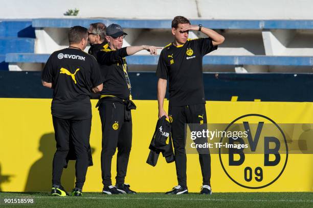 Head coach Peter Stoeger of Dortmund gestures and Assistant coach Manfred Schmid of Dortmund and Assistant coach Joerg Heinrich of Dortmund look on...