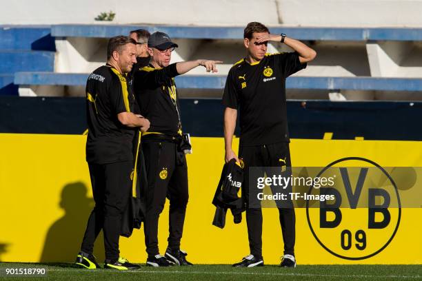 Assistant coach Manfred Schmid, Head coach Peter Stoeger of Dortmund and Assistant coach Joerg Heinrich of Dortmund look on during the Borussia...