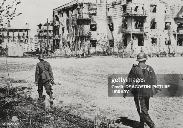 German soldiers among the destroyed buildings in Stalingrad, Russia, World War II, from L'Illustrazione Italiana, Year LXIX, No 42, October 18, 1942.