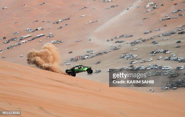Dune buggy driver participates in a sand dune racing event during the Liwa 2018 Moreeb Dune Festival on January 5 in the Liwa desert, some 250...