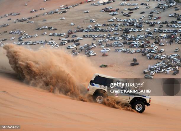 Dune buggy driver participates in a sand dune racing event during the Liwa 2018 Moreeb Dune Festival on January 5 in the Liwa desert, some 250...