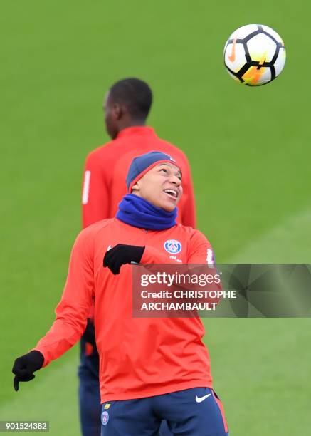 Paris Saint-Germain's French forward Kylian Mbappe plays the ball during a training session of French L1 football club Paris Saint-Germain in...