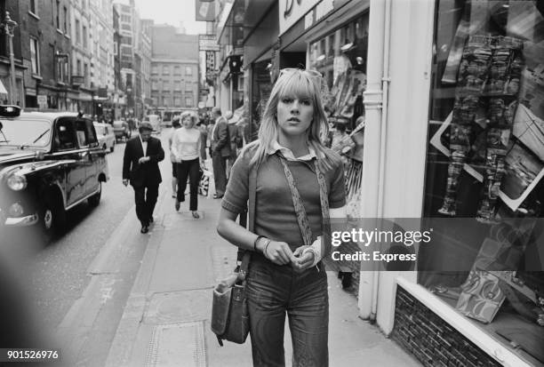 French singer and actress Sylvie Vartan walking in Carnaby Street with her left arm in plaster following a car accident, London, UK, 10th June 1968.