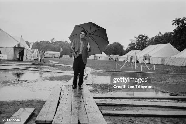 Professional golfer Tony Jacklin inspecting waterlogged course during the Piccadilly World Match Play Championship, Virginia Water, UK, October 1968.