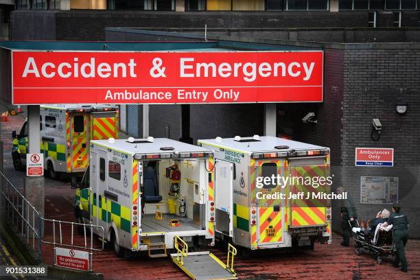 Ambulances sit at the accident and emergency at the Glasgow Royal hospital on January 5, 2018 in Glasgow, Scotland. Hospitals across the country are...