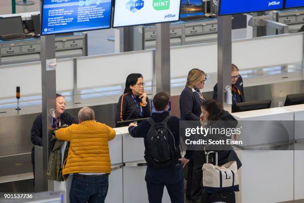 Customers at a JetBlue counter at Logan International Airport following a "bomb cyclone" the previous day on January 5, 2018 in Boston,...