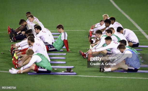 Players exercise with Pilates coach Peter Schloesser during a training session on day 4 of the FC Bayern Muenchen training camp at ASPIRE Academy for...