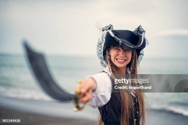 fierce pirate girl holding a sabre - period costume stock pictures, royalty-free photos & images