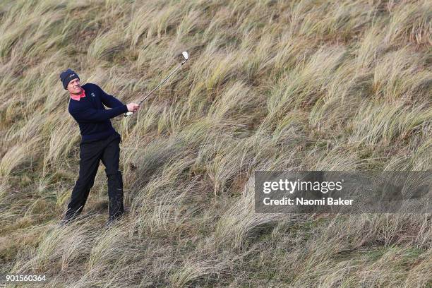 Mark Benka of Lady Margaret Hall College Oxford plays a shot out of the long grass during the Oxford and Cambridge Golfing Society President's Putter...