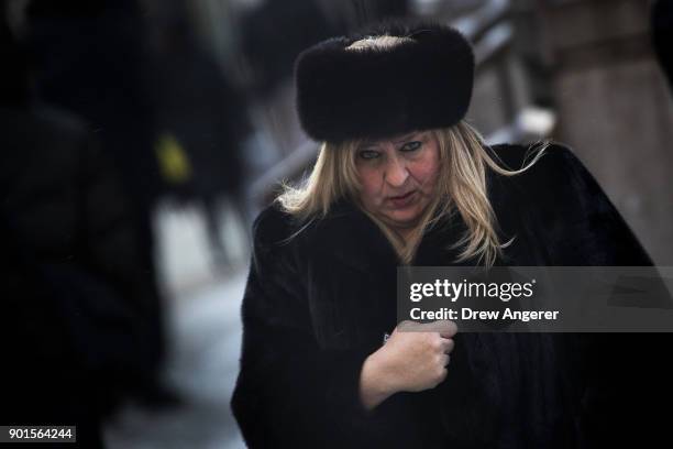 Bundled up pedestrian walks through the Financial District, January 5, 2018 in New York City. Brutally cold temperatures and wind chills are expected...