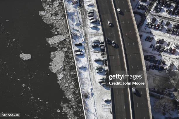 Ice floats on the Harlem River next to the Harlem River Drive on January 5, 2018 in New York City. Under frigid temperatures, New York City dug out...