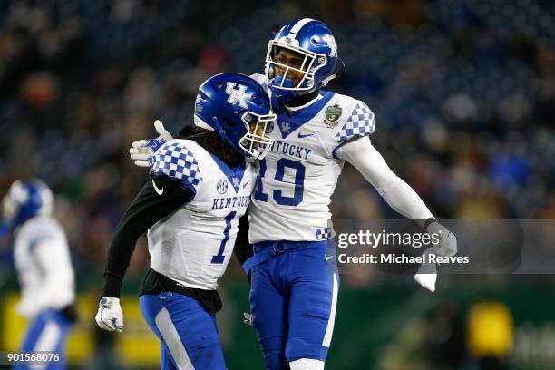 Kayaune Ross of the Kentucky Wildcats celebrates with Lynn Bowden Jr. #1 against the Northwestern Wildcats during the Music City Bowl at Nissan...