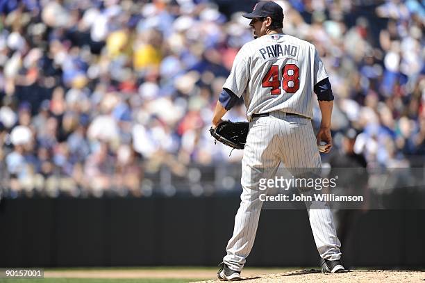 Pitcher Carl Pavano of the Minnesota Twins looks to the catcher for the sign before delivering a pitch during the game against the Kansas City Royals...
