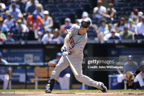 Joe Mauer of the Minnesota Twins bats during the game against the Kansas City Royals at Kauffman Stadium in Kansas City, Missouri on Sunday, August...