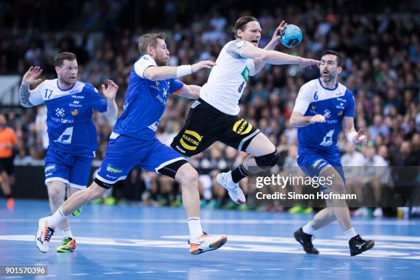 Tobias Reichmann of Germany is challenged by Gudjon Sigurdsson of Iceland during the International Handball Friendly match between Germany and...