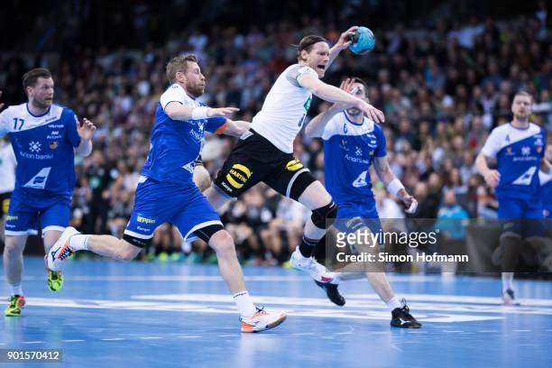Tobias Reichmann of Germany is challenged by Gudjon Sigurdsson of Iceland during the International Handball Friendly match between Germany and...