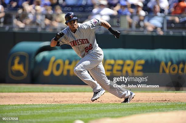 Carlos Gomez of the Minnesota Twins runs on the pitch from first base during the game against the Kansas City Royals at Kauffman Stadium in Kansas...