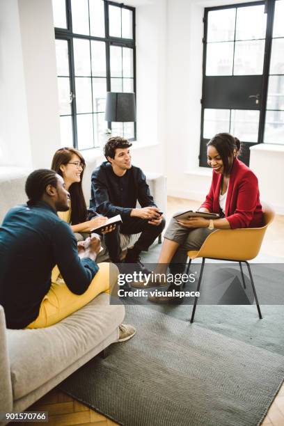 multi-ethnic group of young entrepreneurs working - yellow note pad stock pictures, royalty-free photos & images