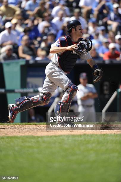 Catcher Joe Mauer of the Minnesota Twins fields his position as he runs from behind home plate to field a bunt attempt during the game against the...