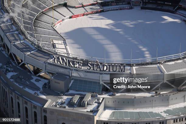 Yankee Stadium stands under a blanket of snow on January 5, 2018 in the Bronx Borough of New York City. Under frigid temperatures, New York City dug...