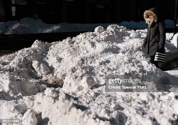 Woman walks through the snow the morning after a massive winter storm on January 5, 2018 in Boston, United States. Schools and businesses throughout...