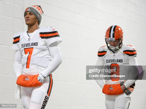 Quarterbacks DeShone Kizer and Kevin Hogan of the Cleveland Browns walks down the tunnel toward the field prior to a game on December 31, 2017...