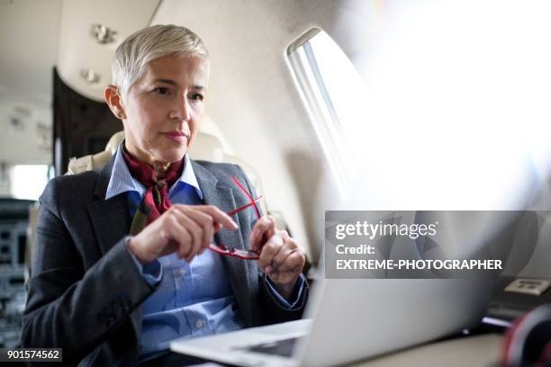 businesswoman in private jet airplane - asset manager stock pictures, royalty-free photos & images