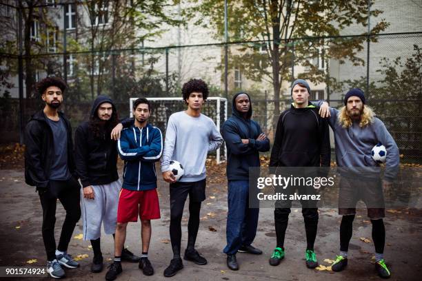 confident soccer team standing on street - street football stock pictures, royalty-free photos & images