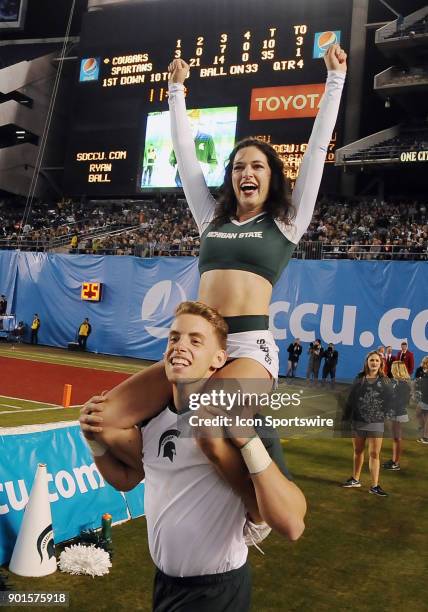 Michigan State Spartans cheerleaders have fun on the field in the second half of the Holiday Bowl played against the Washington State Cougars, on...