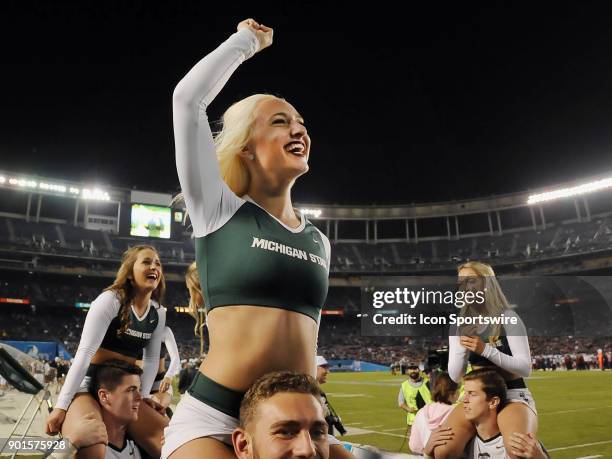 Michigan State Spartans cheerleaders have fun on the field in the second half of the Holiday Bowl played against the Washington State Cougars, on...
