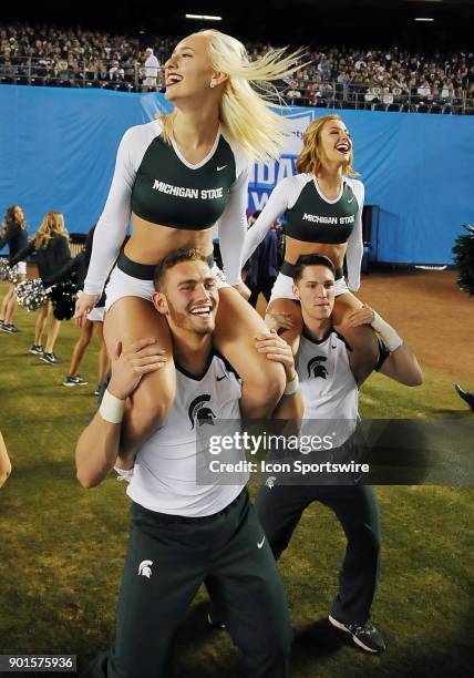 Michigan State Spartans cheerleaders have fun on the field in the second half of the Holiday Bowl played against the Washington State Cougars, on...