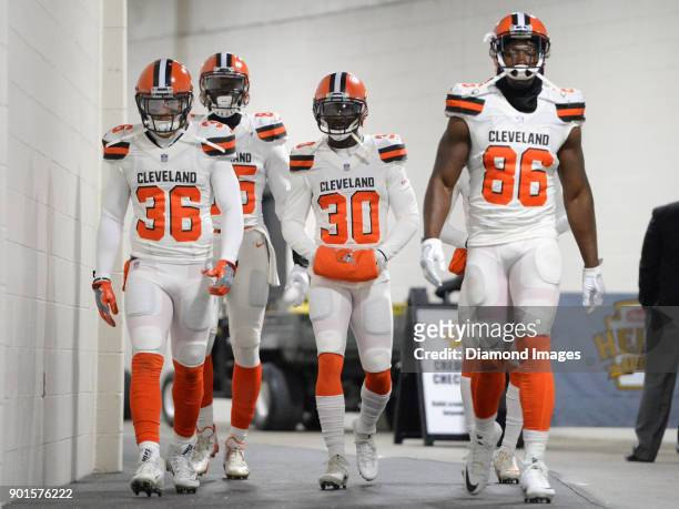 Defensive back Derron Smith, tight end David Njoku, cornerback Jason McCourty and tight end Randall Telfer of the Cleveland Browns walk down the...