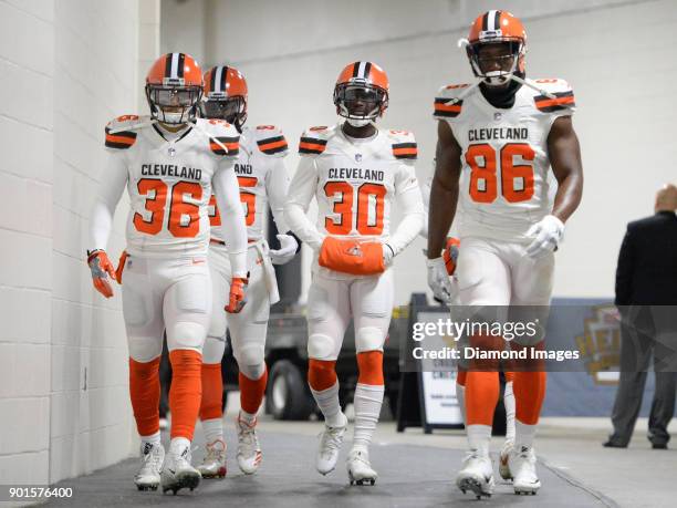 Defensive back Derron Smith, tight end David Njoku, cornerback Jason McCourty and tight end Randall Telfer of the Cleveland Browns walk down the...