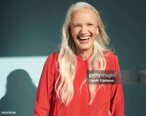 portrait of mature woman laughing - red and white people stock pictures, royalty-free photos & images