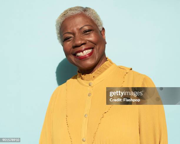 portrait of confident mature woman - senior woman studio stock pictures, royalty-free photos & images