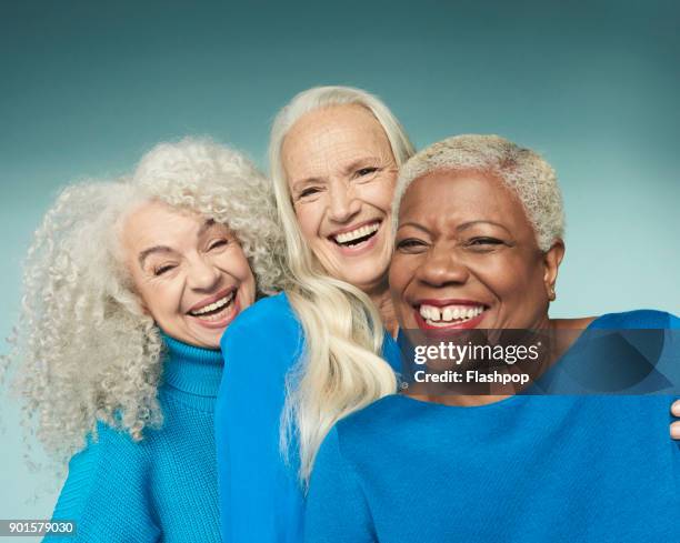 group portrait of three mature women smiling - 3 old people stock-fotos und bilder