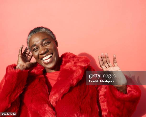 portrait of mature woman laughing - red fun stock pictures, royalty-free photos & images
