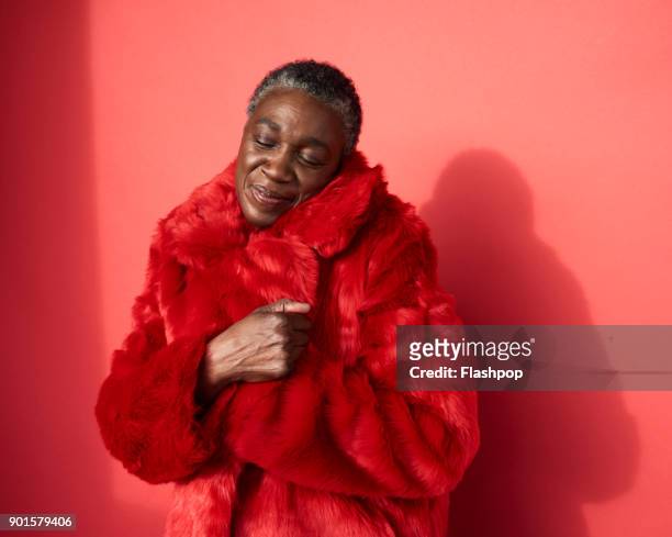 portrait of confident mature woman - fur coat stockfoto's en -beelden