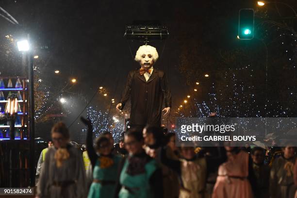 Entertainers hold a giant puppet depicting theoretical physicist Albert Einstein during the traditional Three Kings parade marking Epiphany in Madrid...