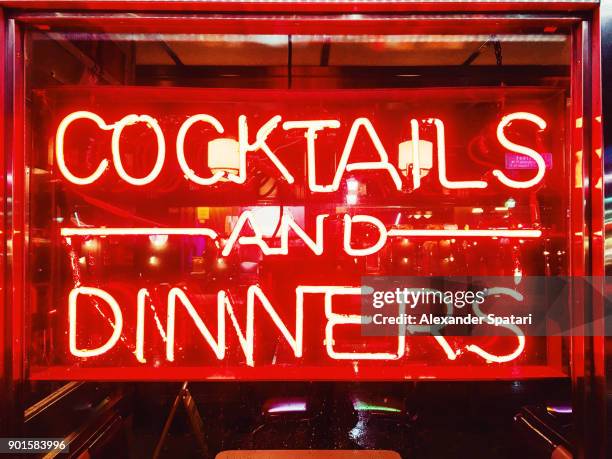 cocktails and dinners red illuminated neon sign - florida nightlife stock pictures, royalty-free photos & images