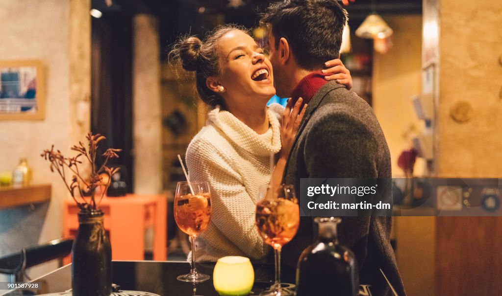Flirting couple in bar