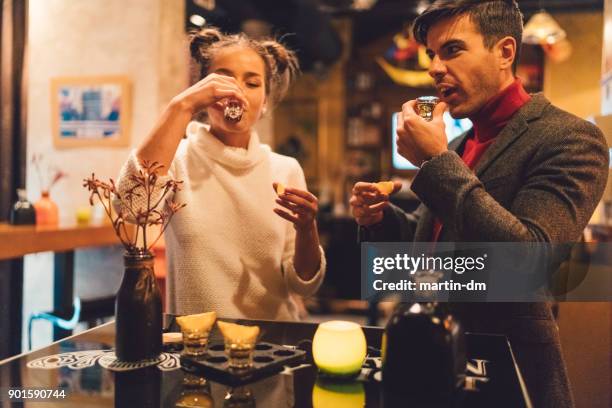 friends enjoying tequila shots - tequila drink stock pictures, royalty-free photos & images