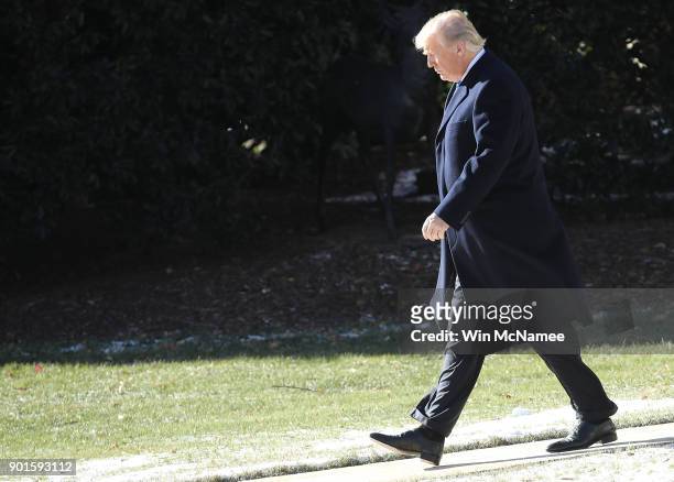 President Donald Trump walks from the Oval Office while departing the White House January 5, 2018 in Washington, DC. Trump is scheduled to spend the...