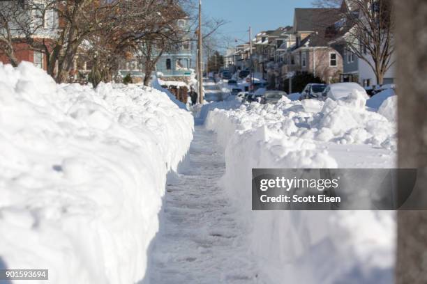 Shoveled sidewalk is seen the day after the region was hit with a "bomb cyclone" on January 5, 2018 in the Dorchester neighborhood of Boston,...