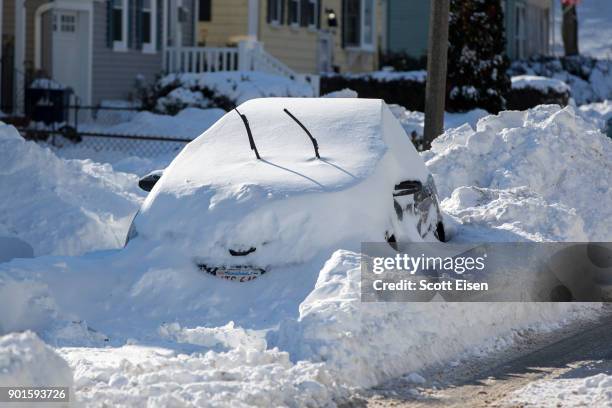 Snowed in vehicle is left parked the day after the region was hit with a "bomb cyclone" on January 5, 2018 in the Dorchester neighborhood of Boston,...