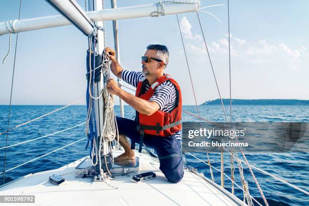 Man Pulling Rope And A Ship Photos and Premium High Res Pictures ...