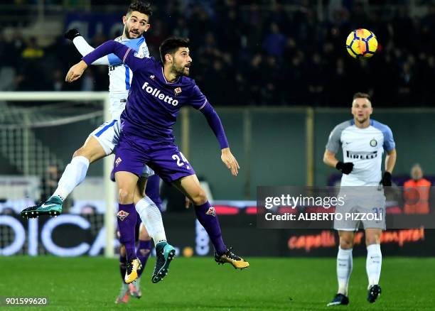 Inter Milan's midfielder Roberto Gagliardini fights for the ball with Fiorentina's Italian midfielder Marco Benassi during the Italian Serie A...