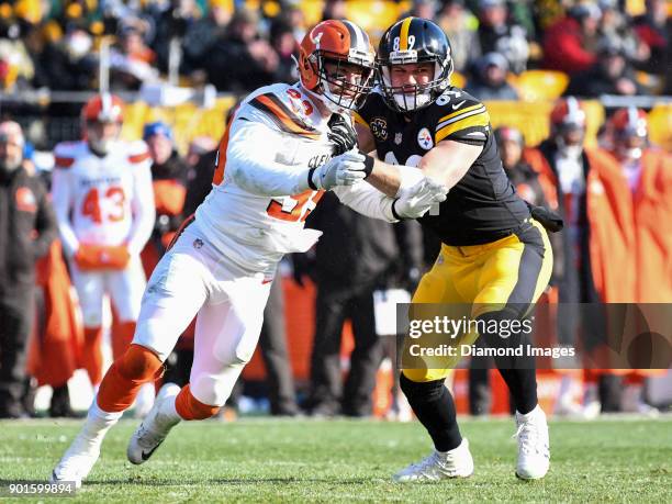 Defensive back Justin Currie of the Cleveland Browns engages tight end Vance McDonald of the Pittsburgh Steelers in the first quarter of a game on...