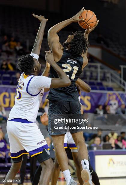East Carolina Pirates forward Usman Haruna guards UCF Knights forward Chad Brown as he goes up for a shot during a game between the East Carolina...