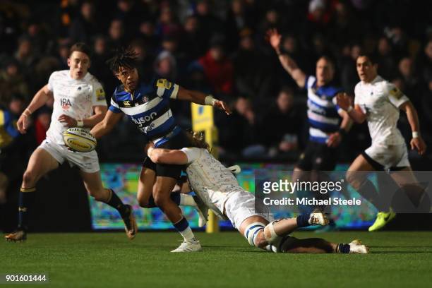 Anthony Watson of Bath looks for support as David Denton of Worcester holds on in the tackle during the Aviva Premiership match between Worcester...